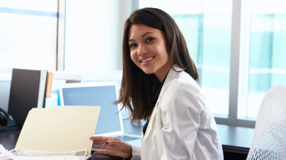 Female dentist in office with paperwork