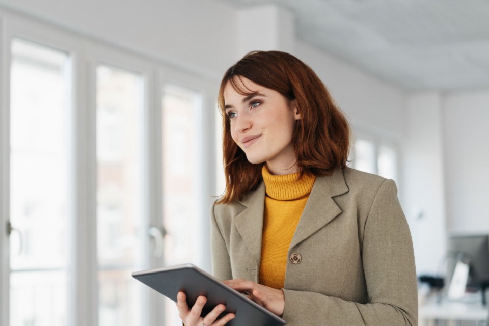 Female professional holding tablet smiling