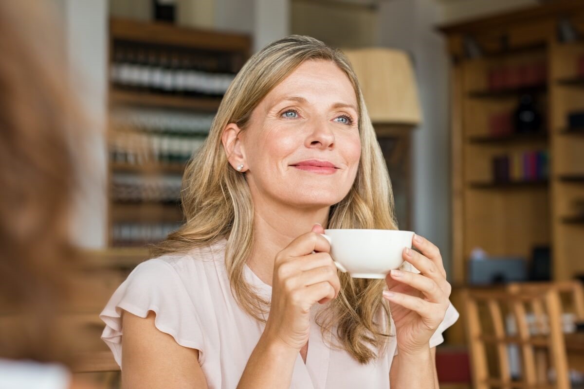 Image of smiling woman holding mug