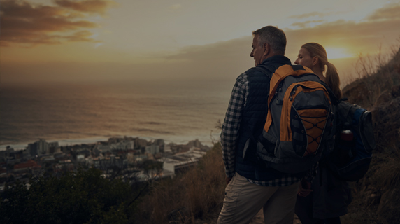 Image of couple with backpacks viewing sunset