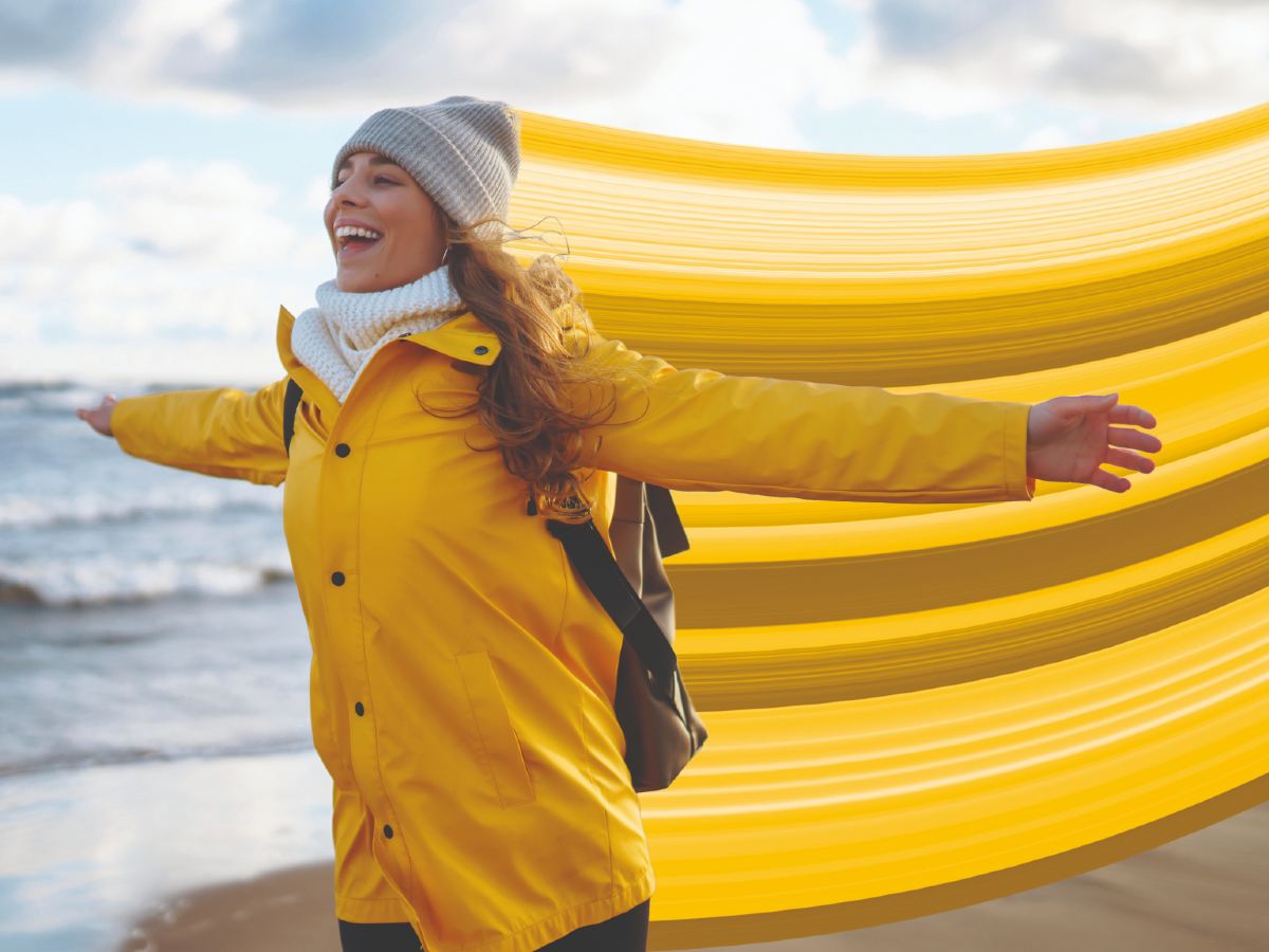 Female running on beach with whoosh