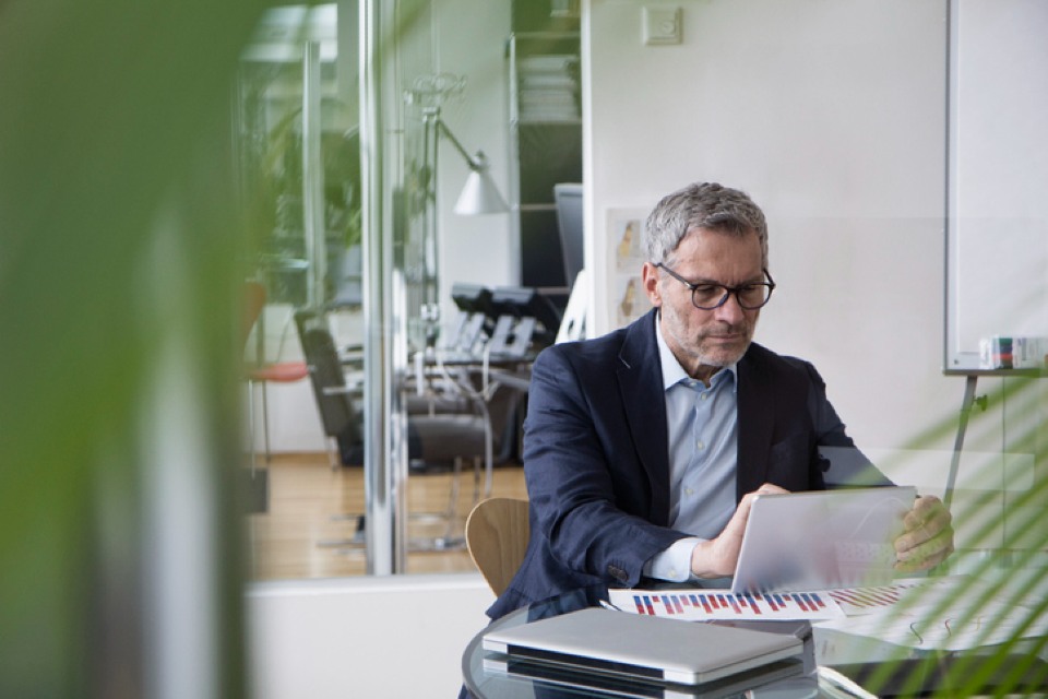 Professional man in office on tablet