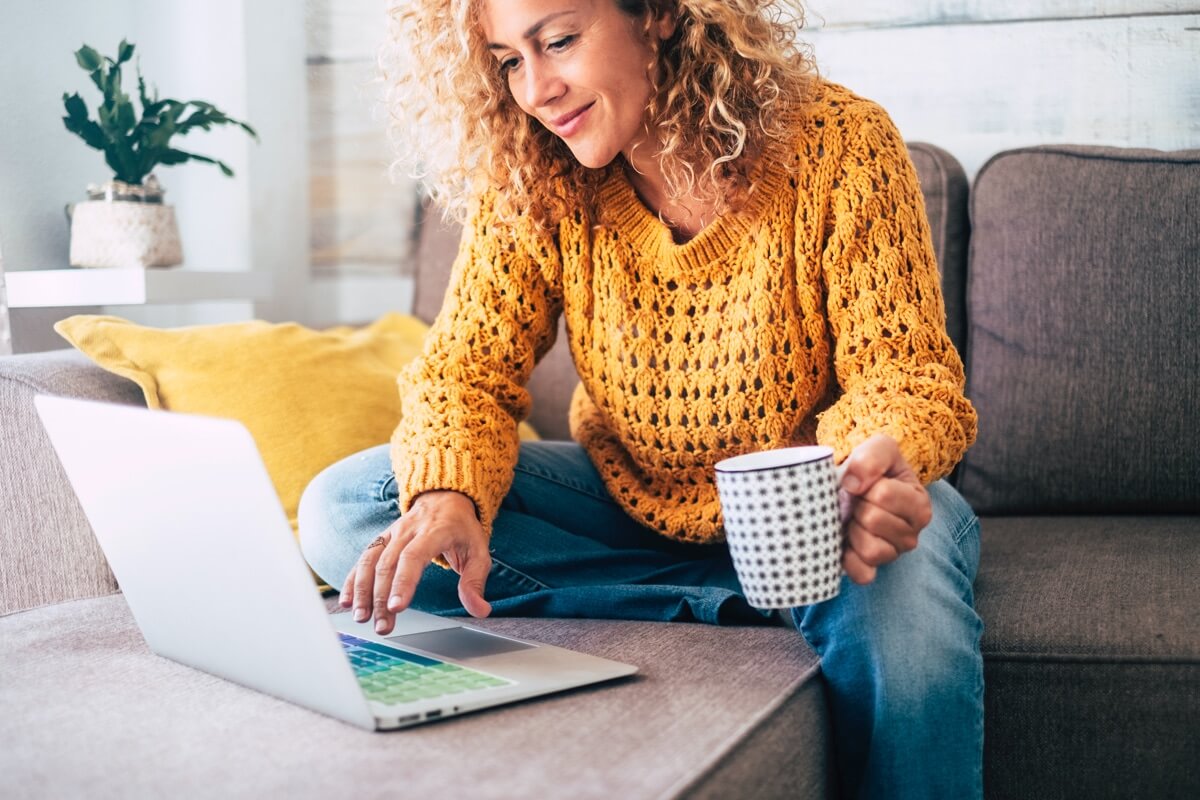 Woman on sofa browsing internet