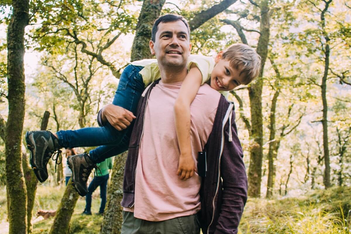 Father playing with son in forest