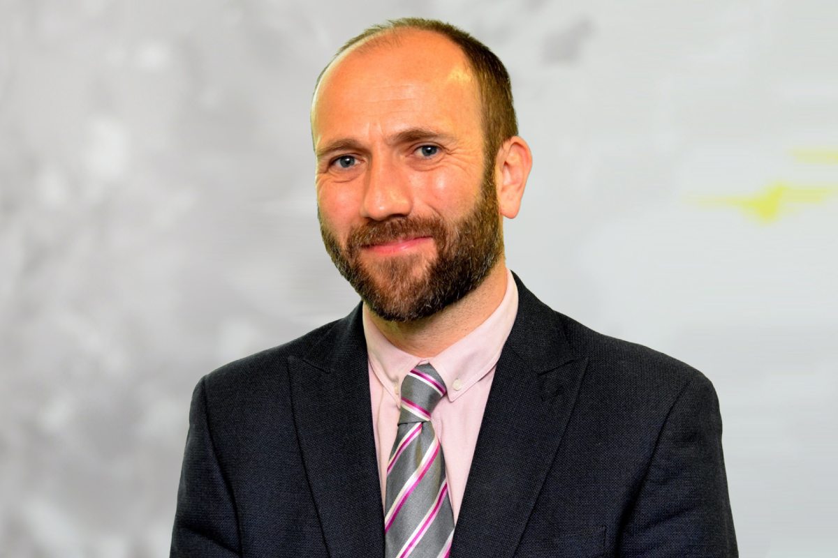 Jonathan Welsh smiling in Wesleyan office