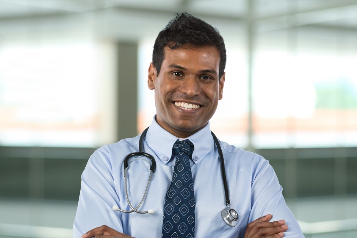 Smiling male doctor wearing stethoscope