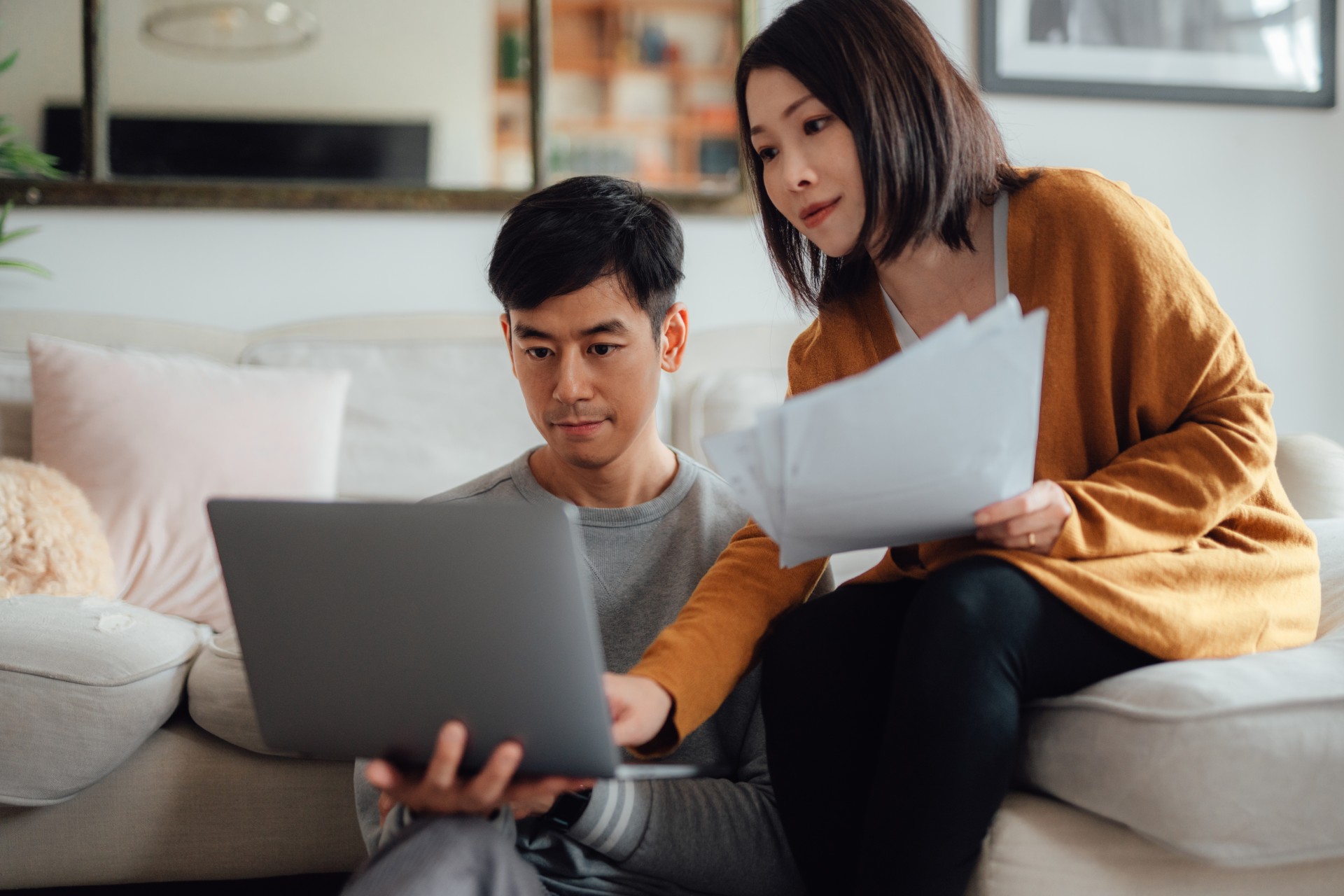 Couple on sofa using laptop