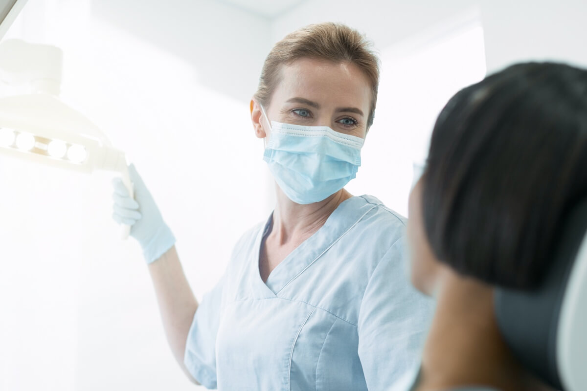 Female dentist with patient in chair