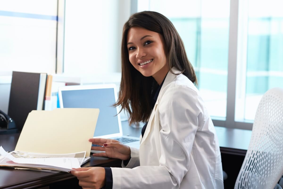 Female gp in office looking at paperwork