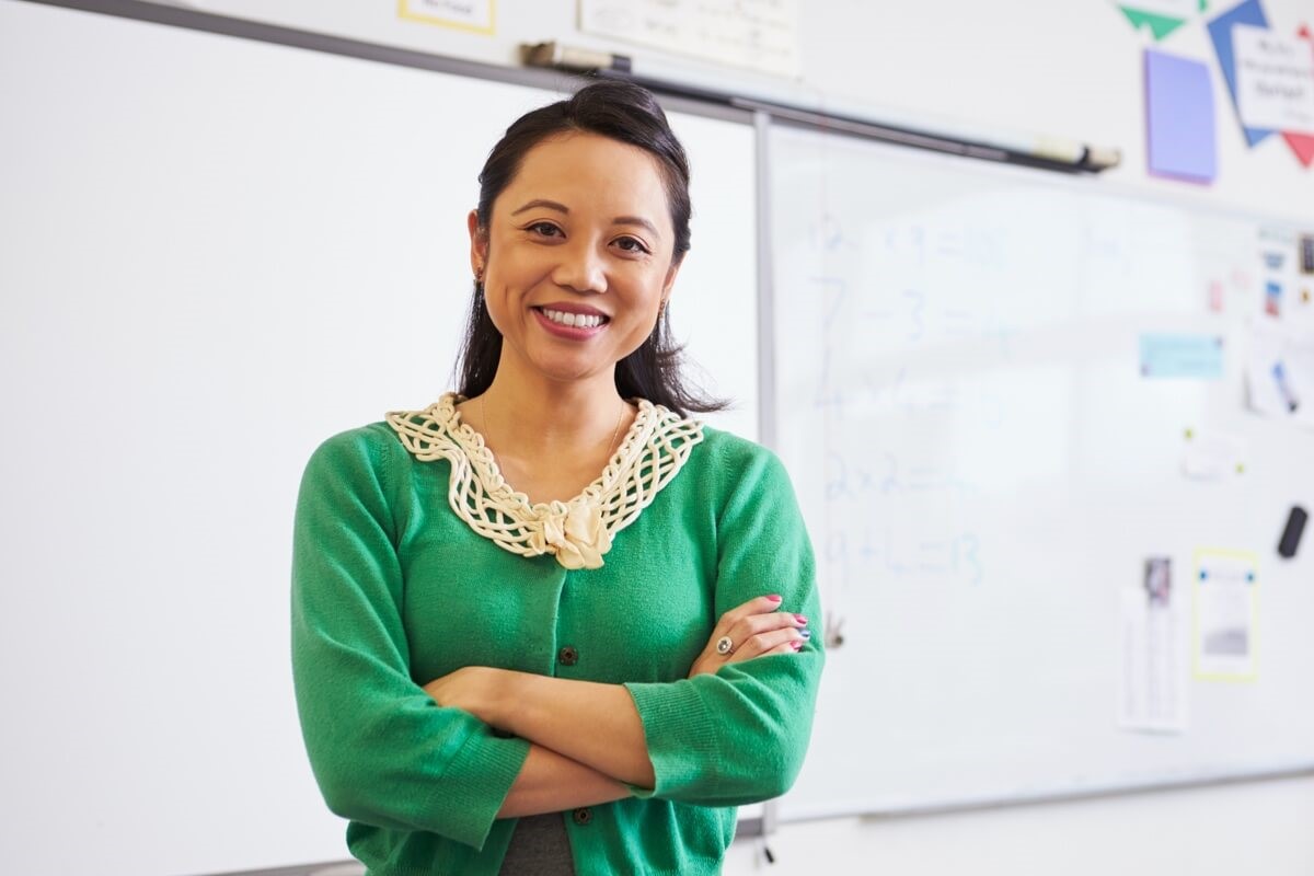 Female teacher standing in front of whiteboard