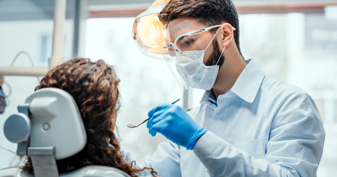 Male dentist with patient