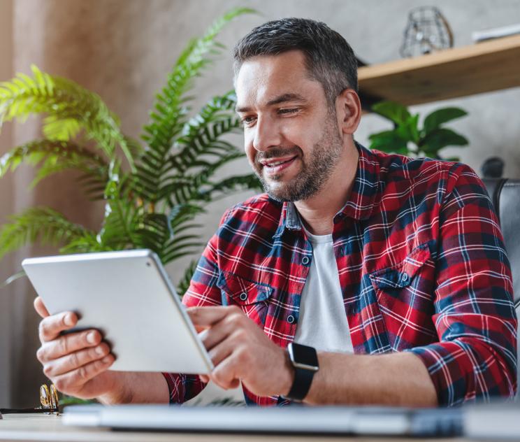 Male holding tablet