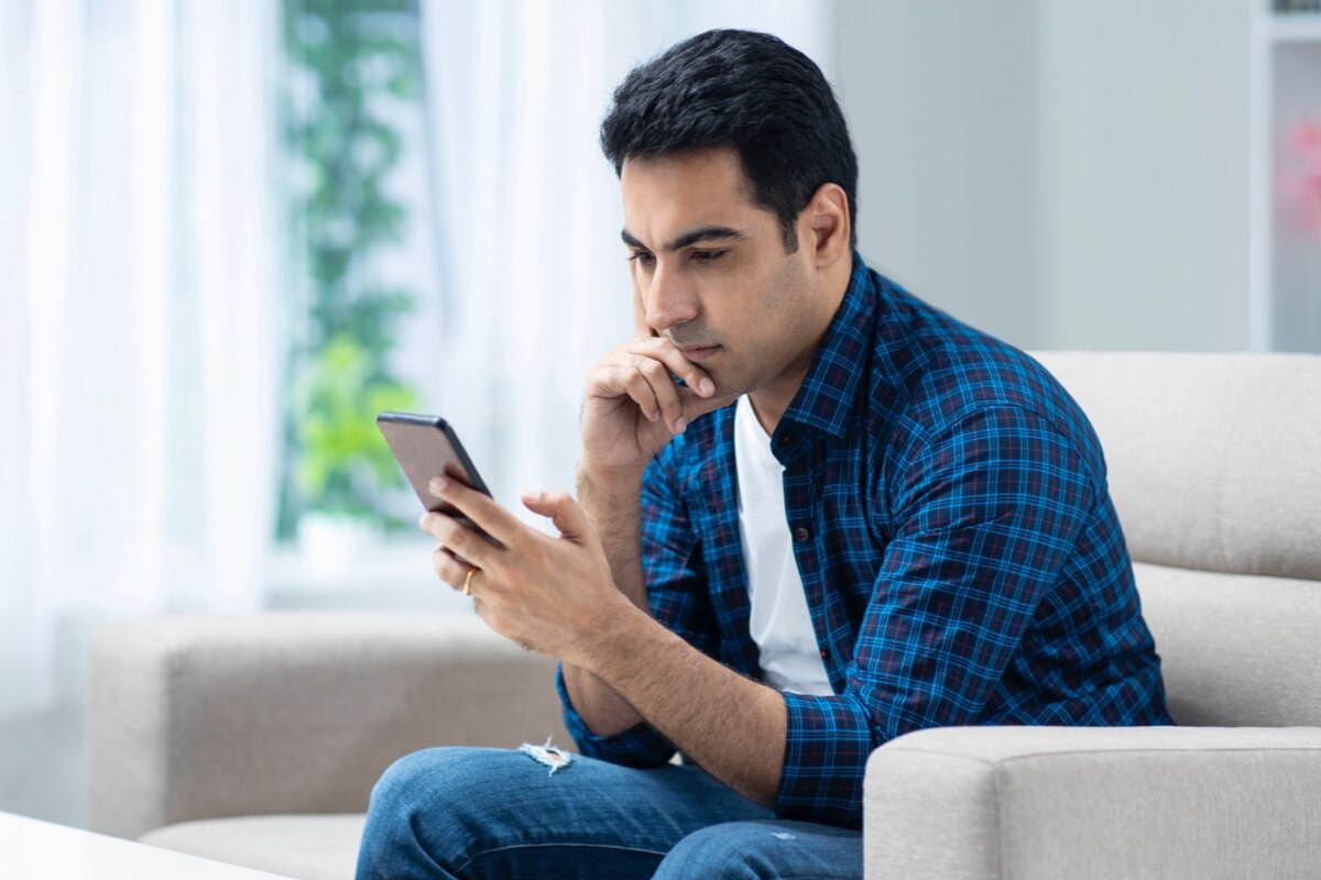 Man looking at phone concerned