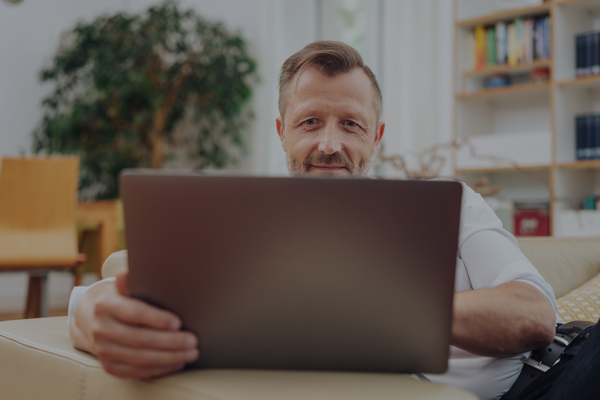 Mature man looking at laptop