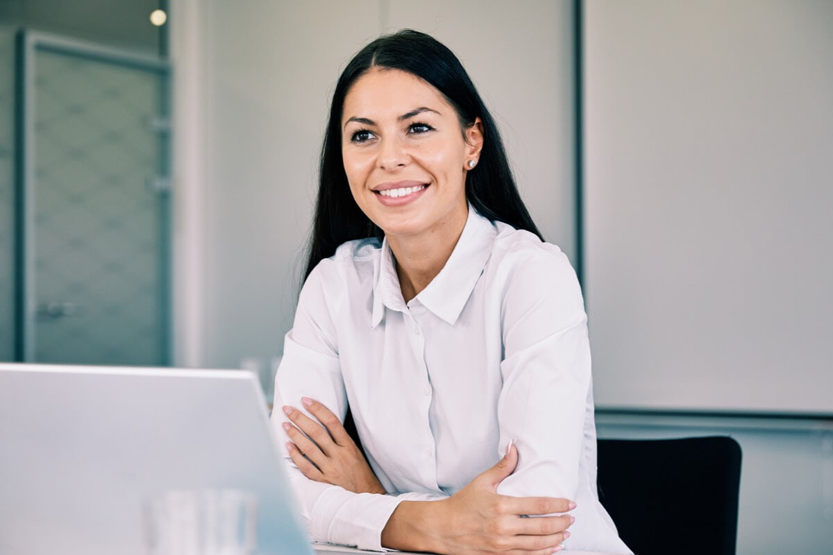 Smart woman smiling at desk