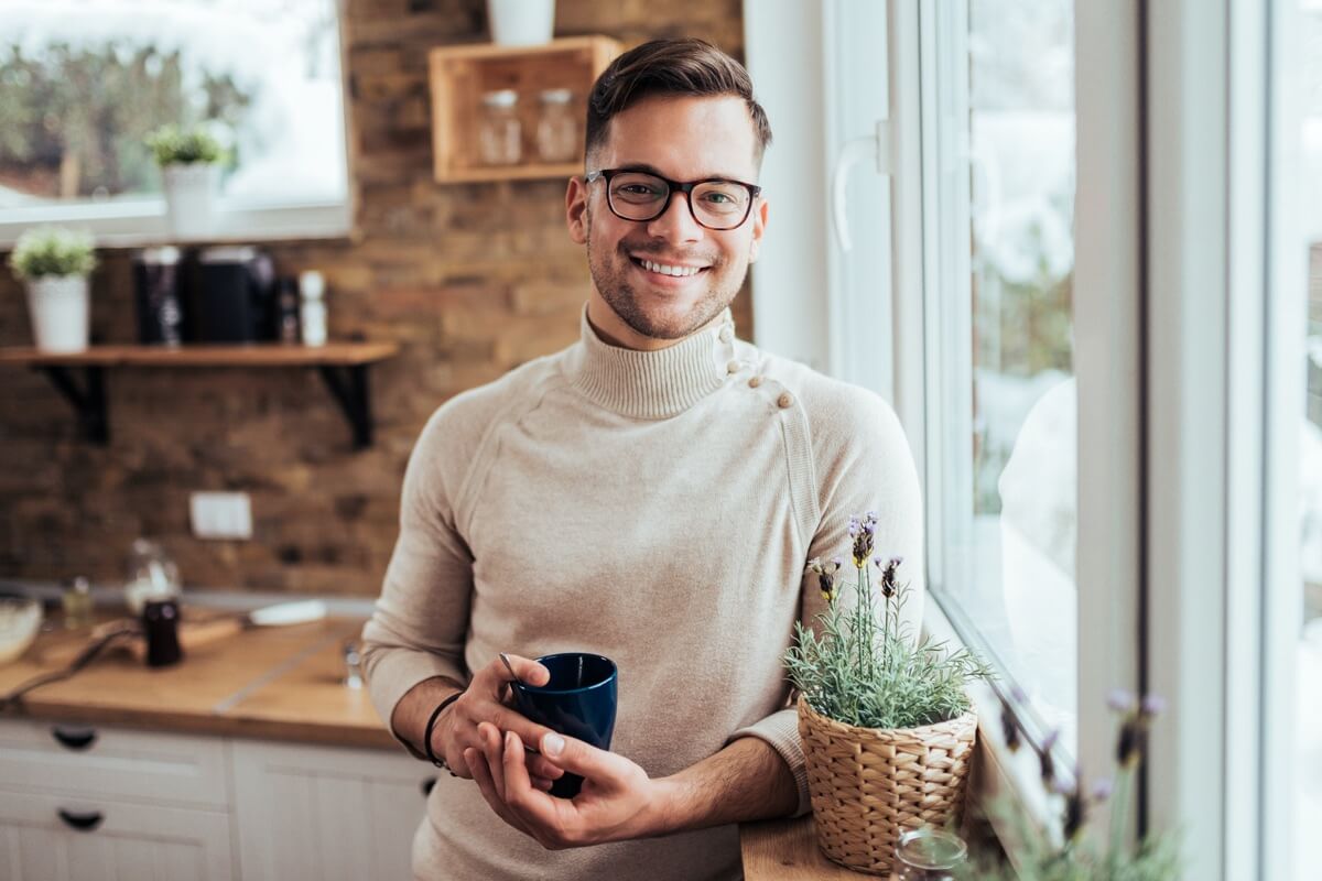 Smiling young man in kitchen