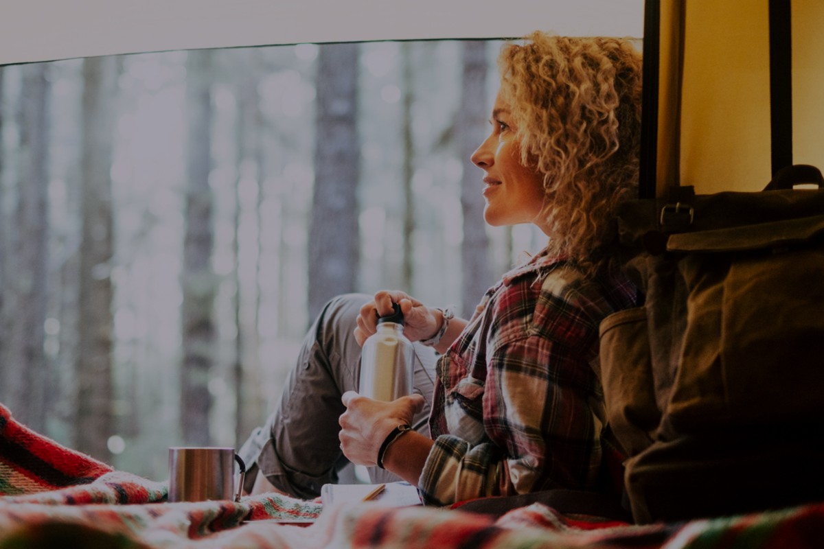 Woman in camper van looking out of window