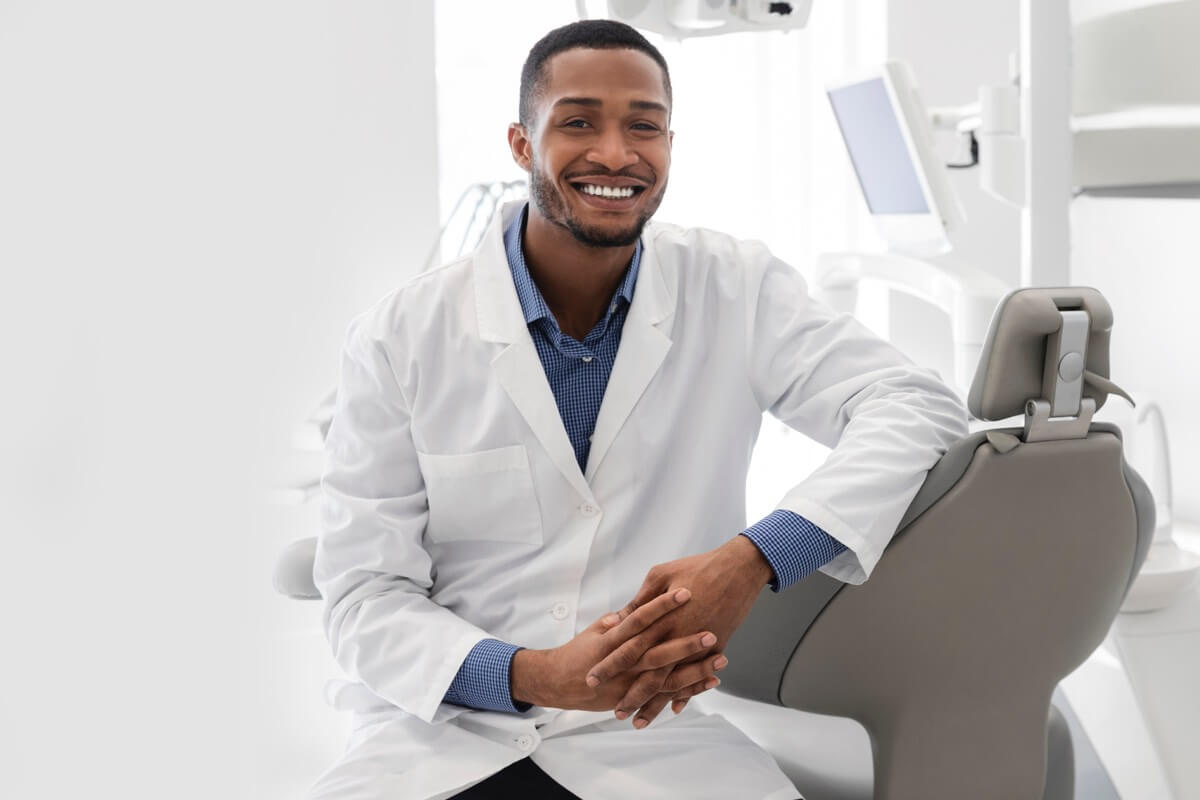 Young male dentist smiling