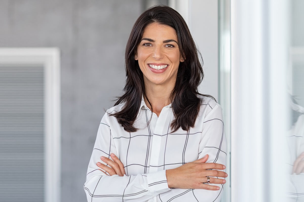 Young professional woman smiling in bright office