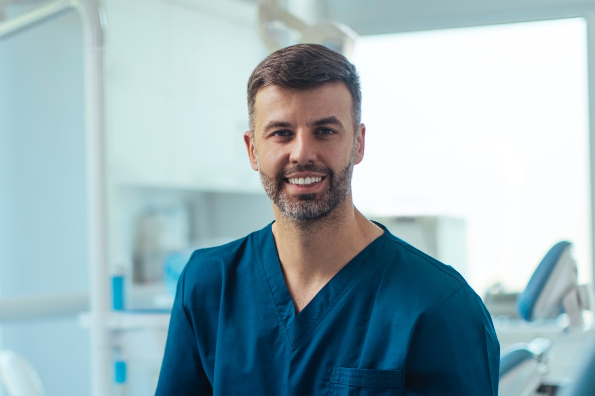 Male dentist in scrubs