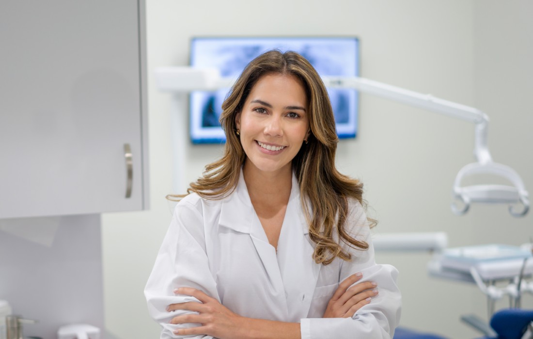 Female dentist in surgery smiling