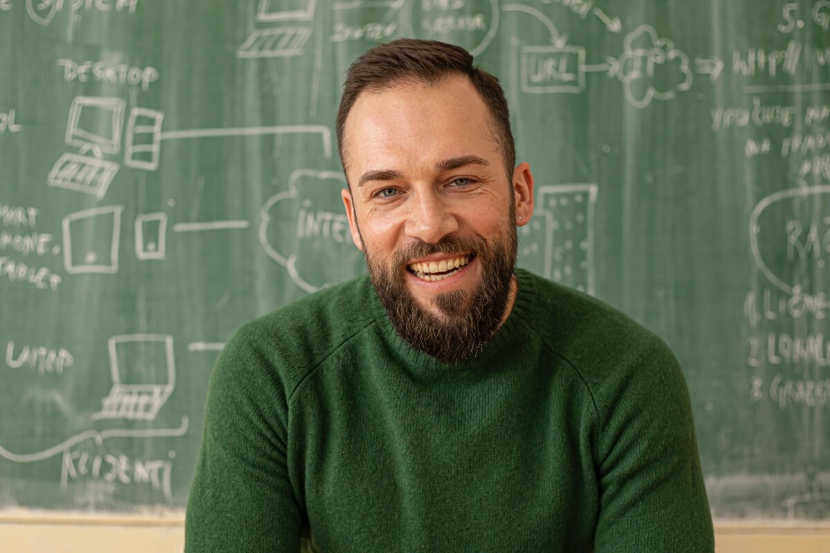 Male teacher in front of chalkboard