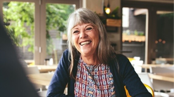 Mature woman smiling in cafe