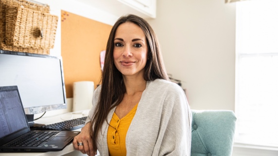 Young woman at desk with laptop