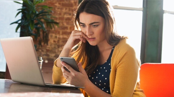 Concerned woman looking at phone