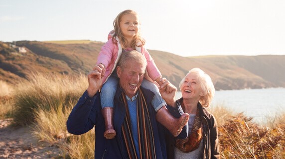 Elderly couple walking with granddaughter