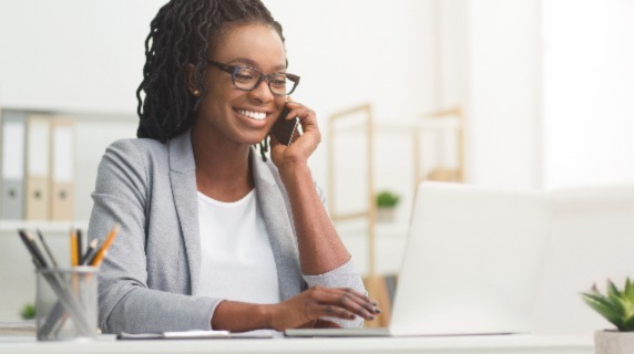 Female professional on laptop and phone