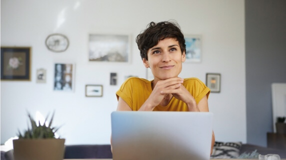 Female sitting at breakfast bar using laptop