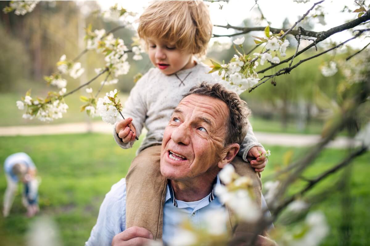 Grandfather carrying grandson