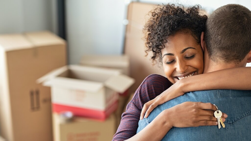 Happy couple moving into home