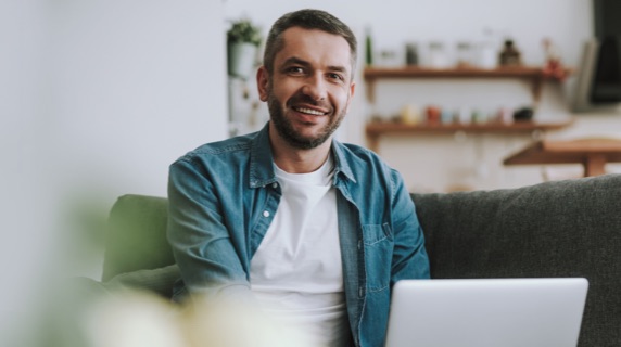 Man on sofa with laptop