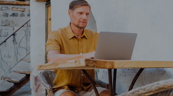 Retirement Club man sitting at desk using laptop