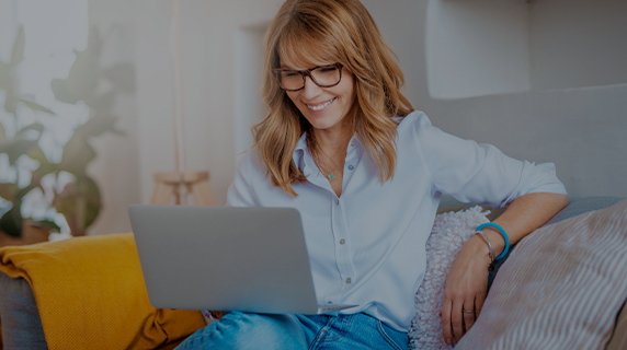 Retirement Club woman on sofa with laptop