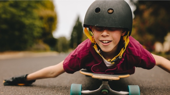 Young boy playing on skateboard