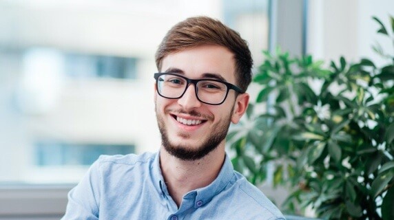 Young male with glasses smiling