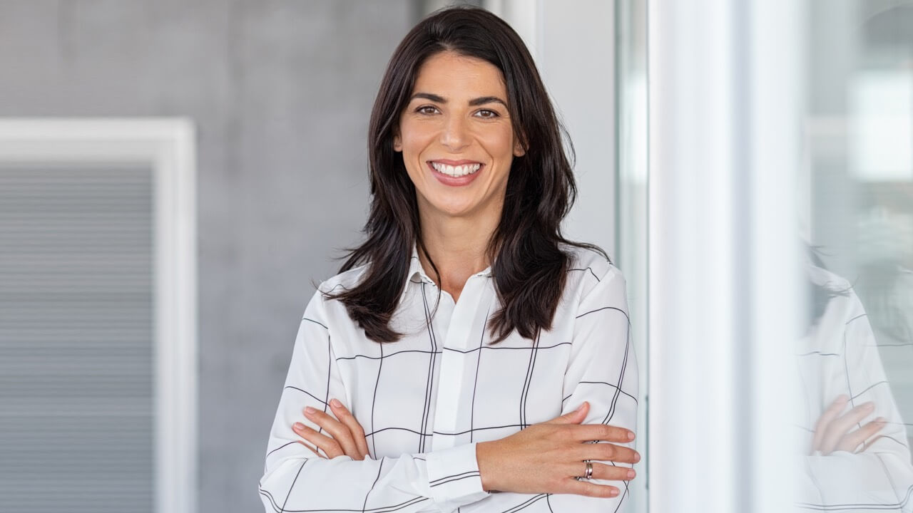 Young professional woman smiling in bright office