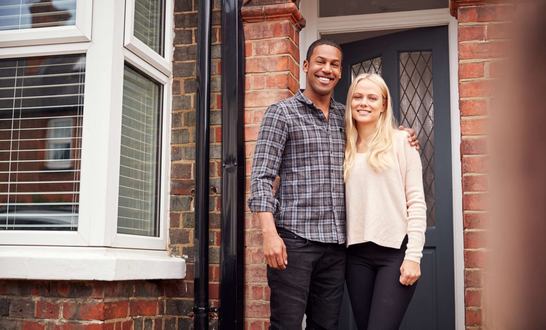 Couple outside of their house