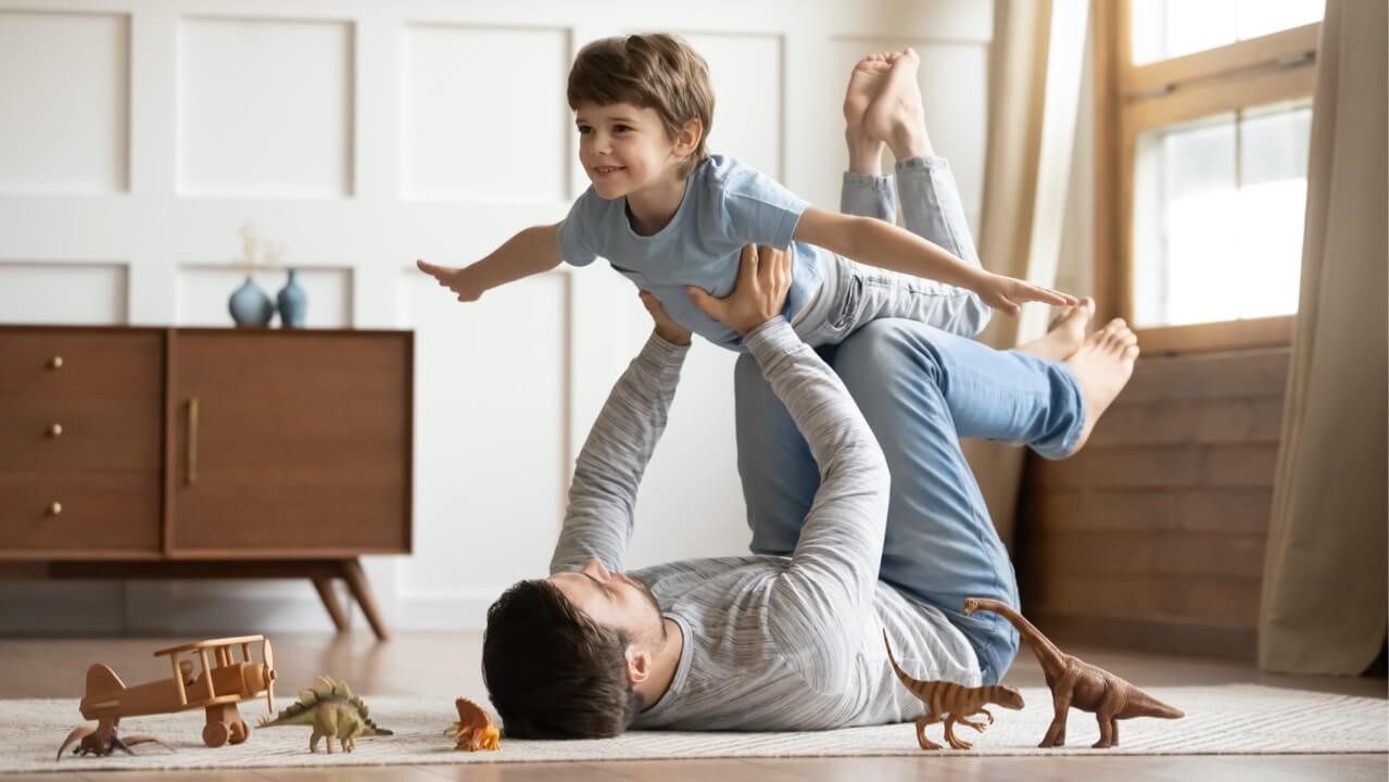 Father playing with toddler son