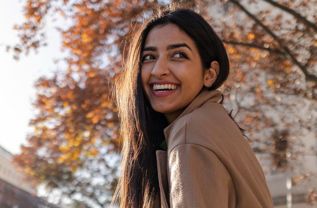 Female in autumn looking back and smiling