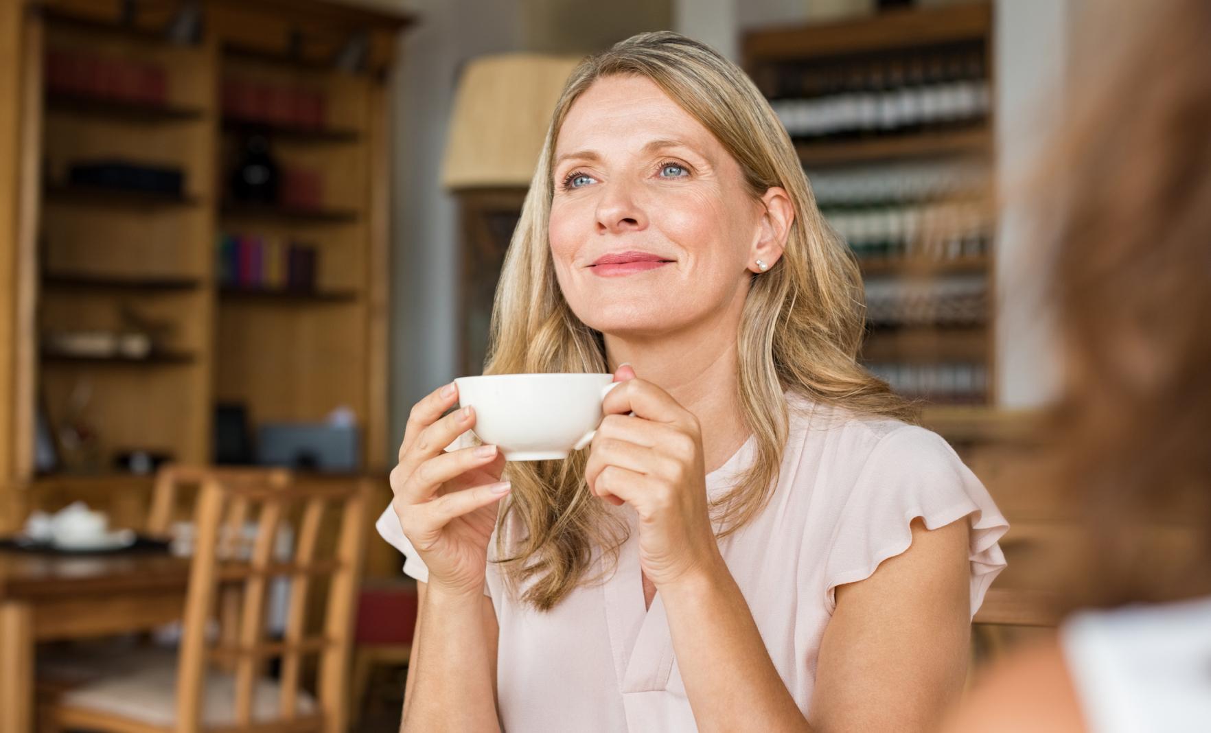 Smiling female holding a cup