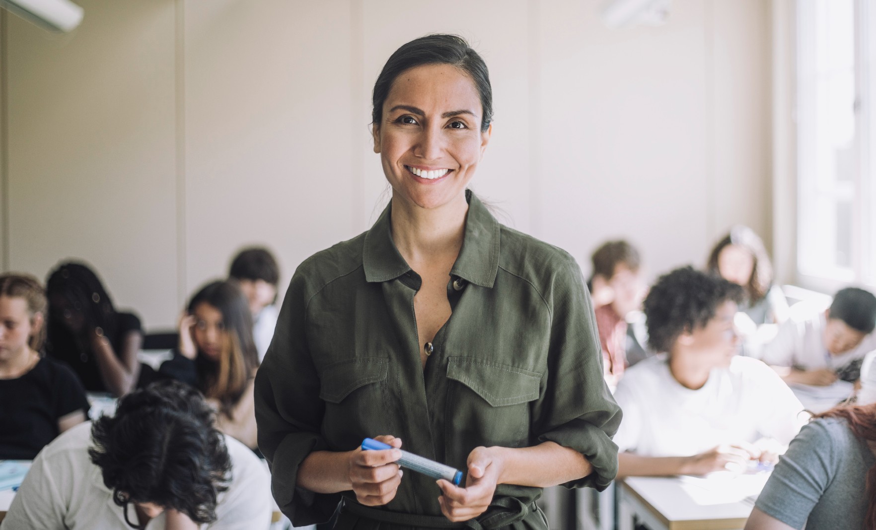 Female teacher smiling in classroom