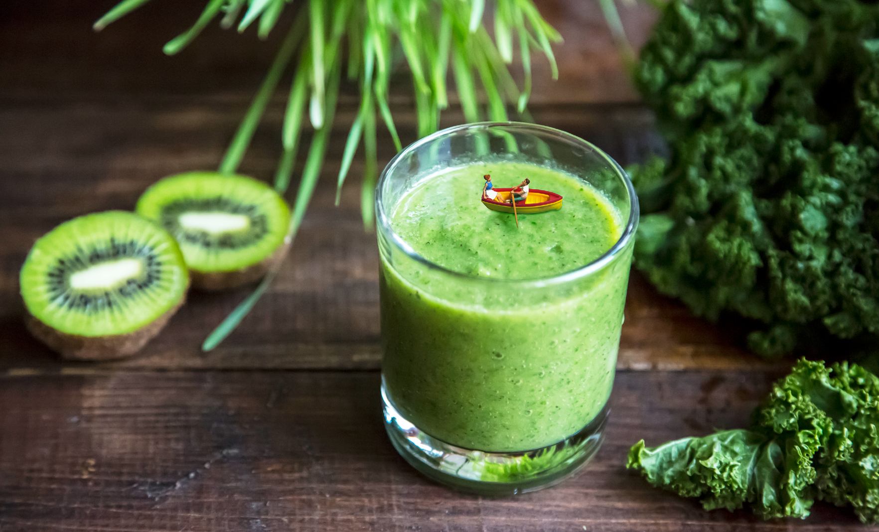 Green smoothie with boat figurine floating on top