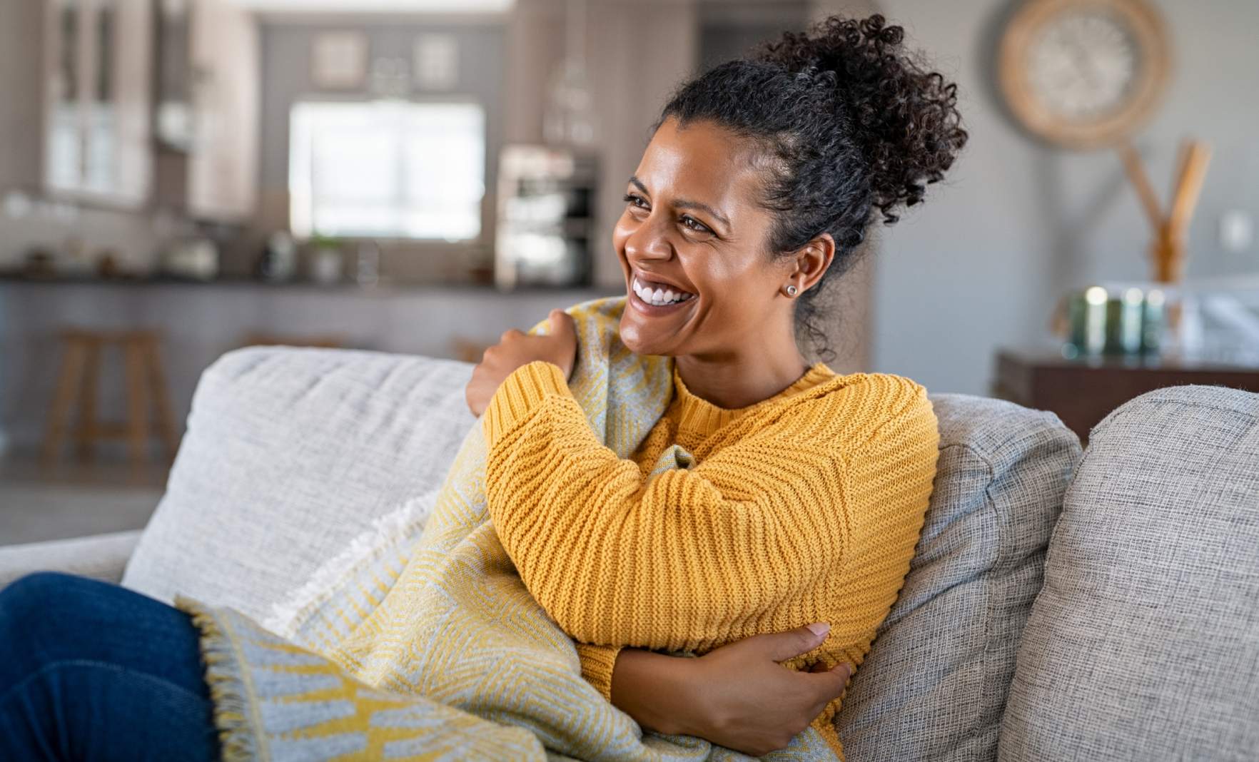 Female sitting on the sofa smiling