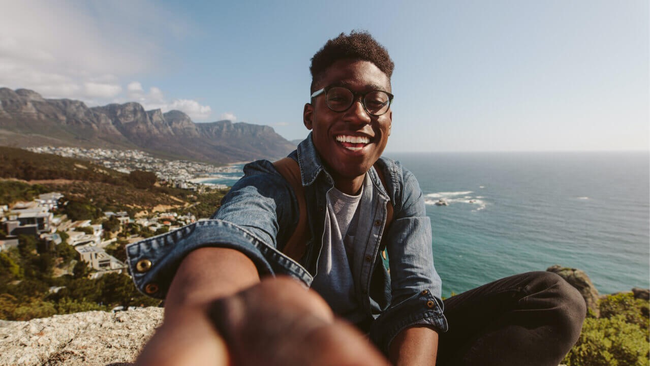 Man taking selfie overlooking beach