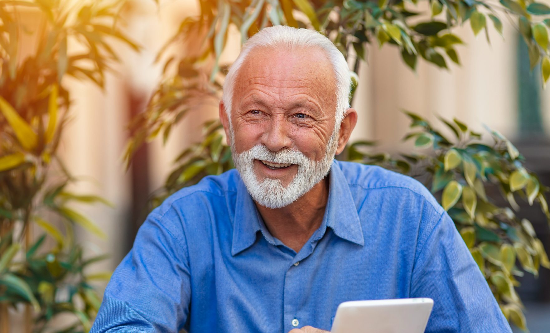 Mature man with tablet device