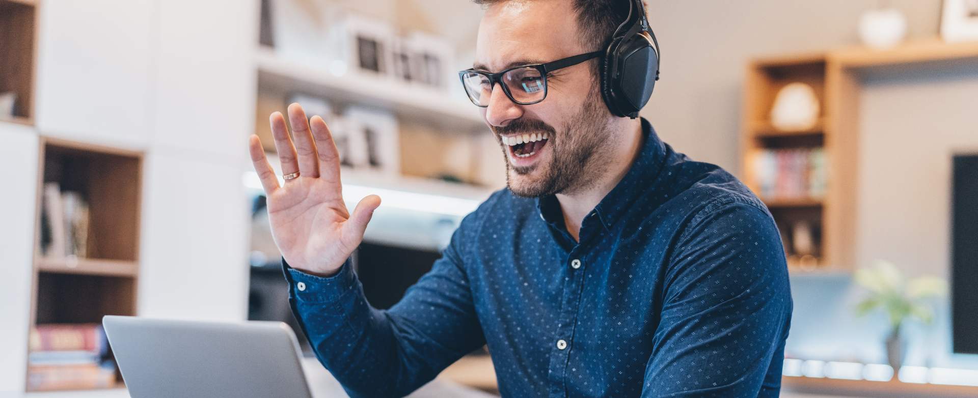 Professional man hearing headset on a laptop call